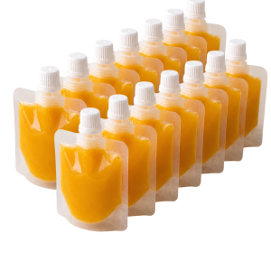 Gingerly Yours ginger and turmeric wellness shot pouches arranged in a row on a white background.