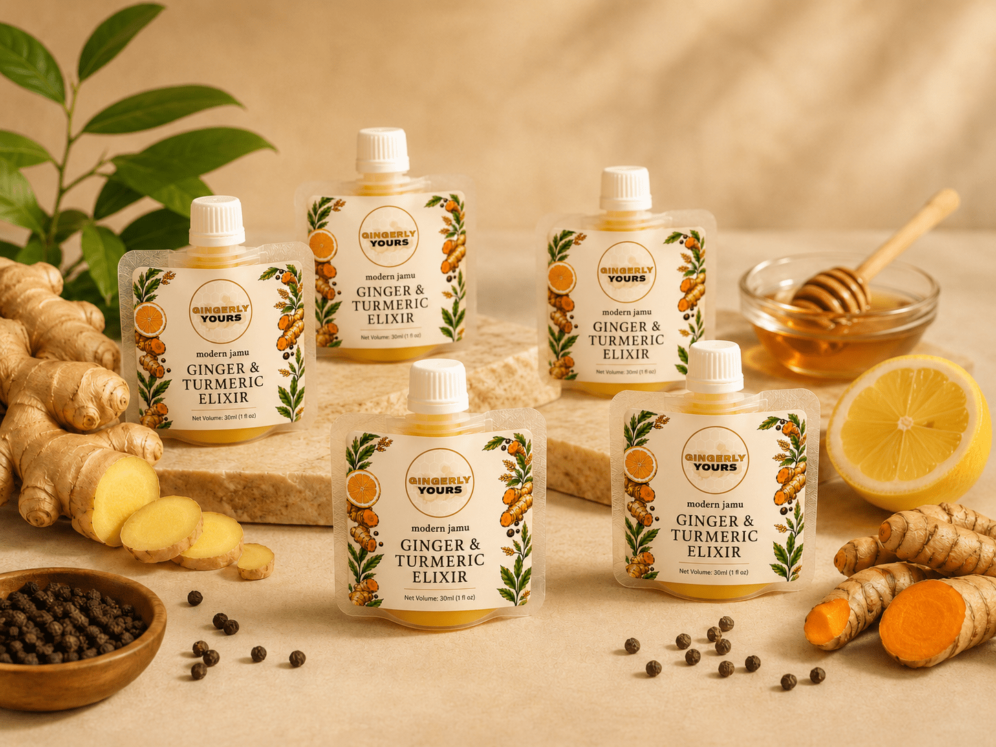 Gingerly Yours ginger and turmeric elixir pouches arranged with fresh ginger, turmeric, lemon, honey, and black pepper on a warm cream background.