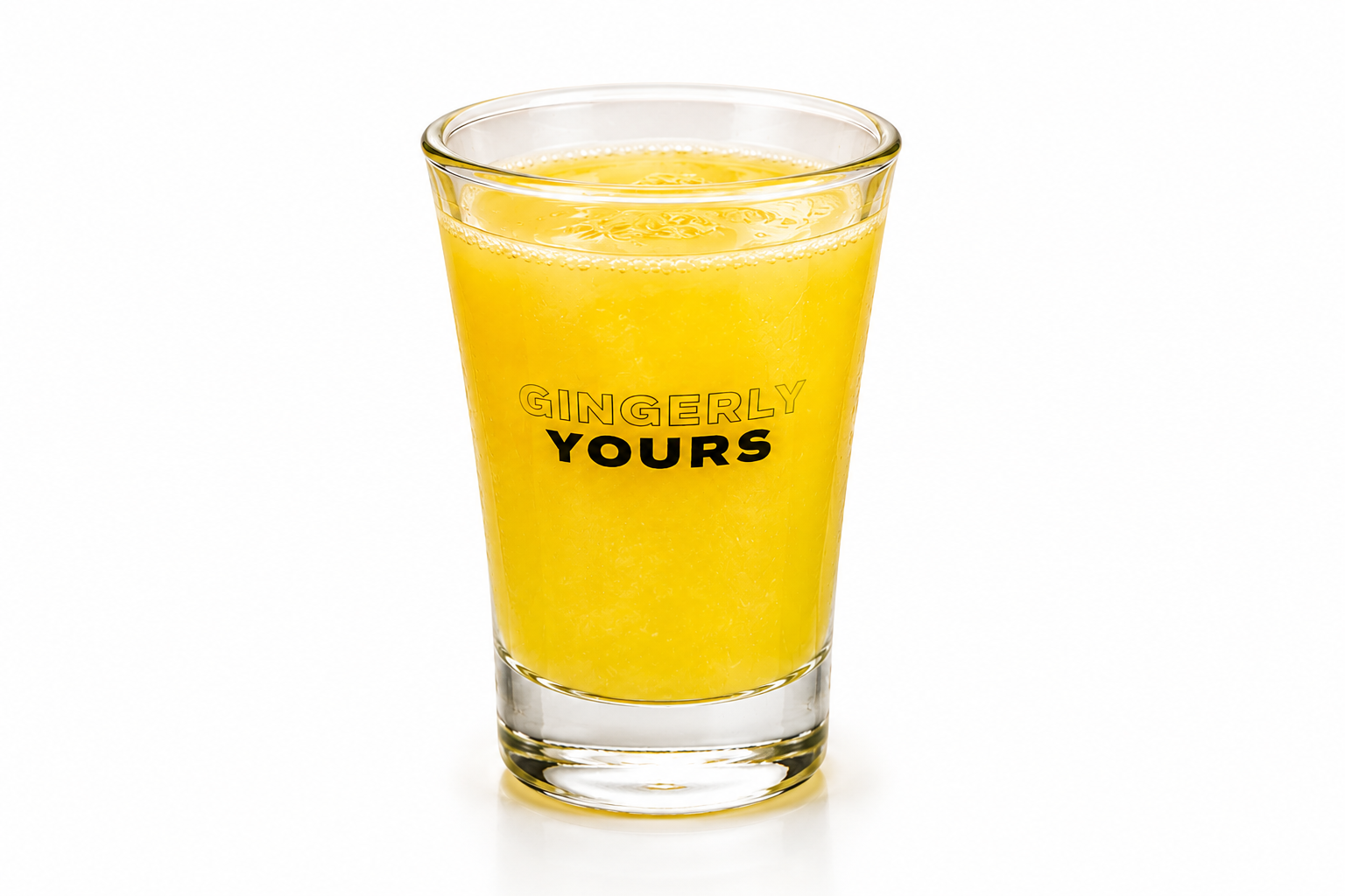 A clear glass filled with a bright yellow drink and ice, branded “Gingerly Yours,” on a white background.