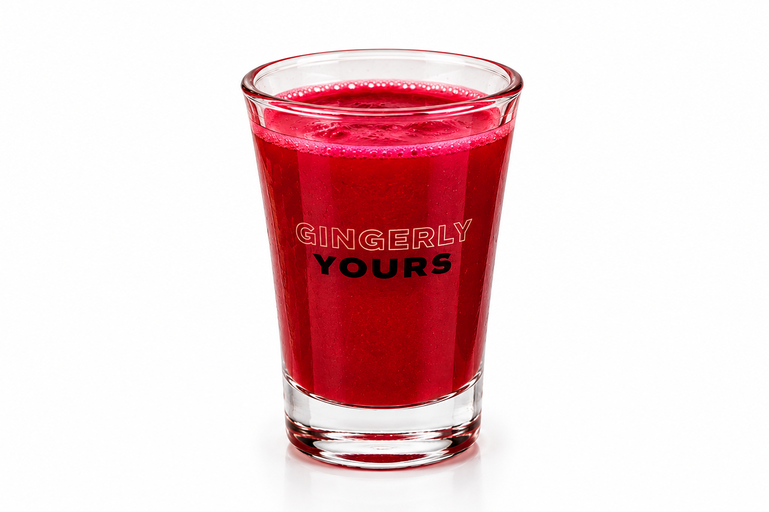A clear glass filled with a vibrant red drink, branded with the words “Gingerly Yours,” against a white background.