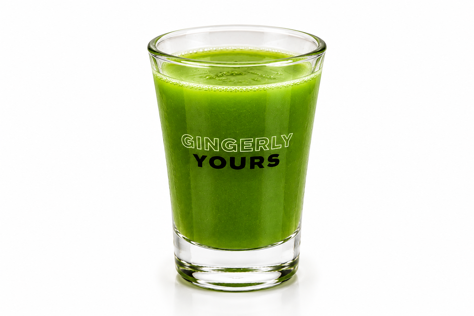 A clear glass filled with a vibrant green drink and ice, branded “Gingerly Yours,” on a white background.